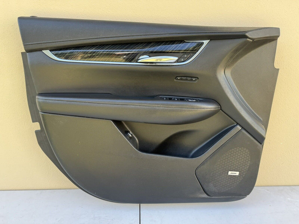 Left driver side front door trim panel with master window switch