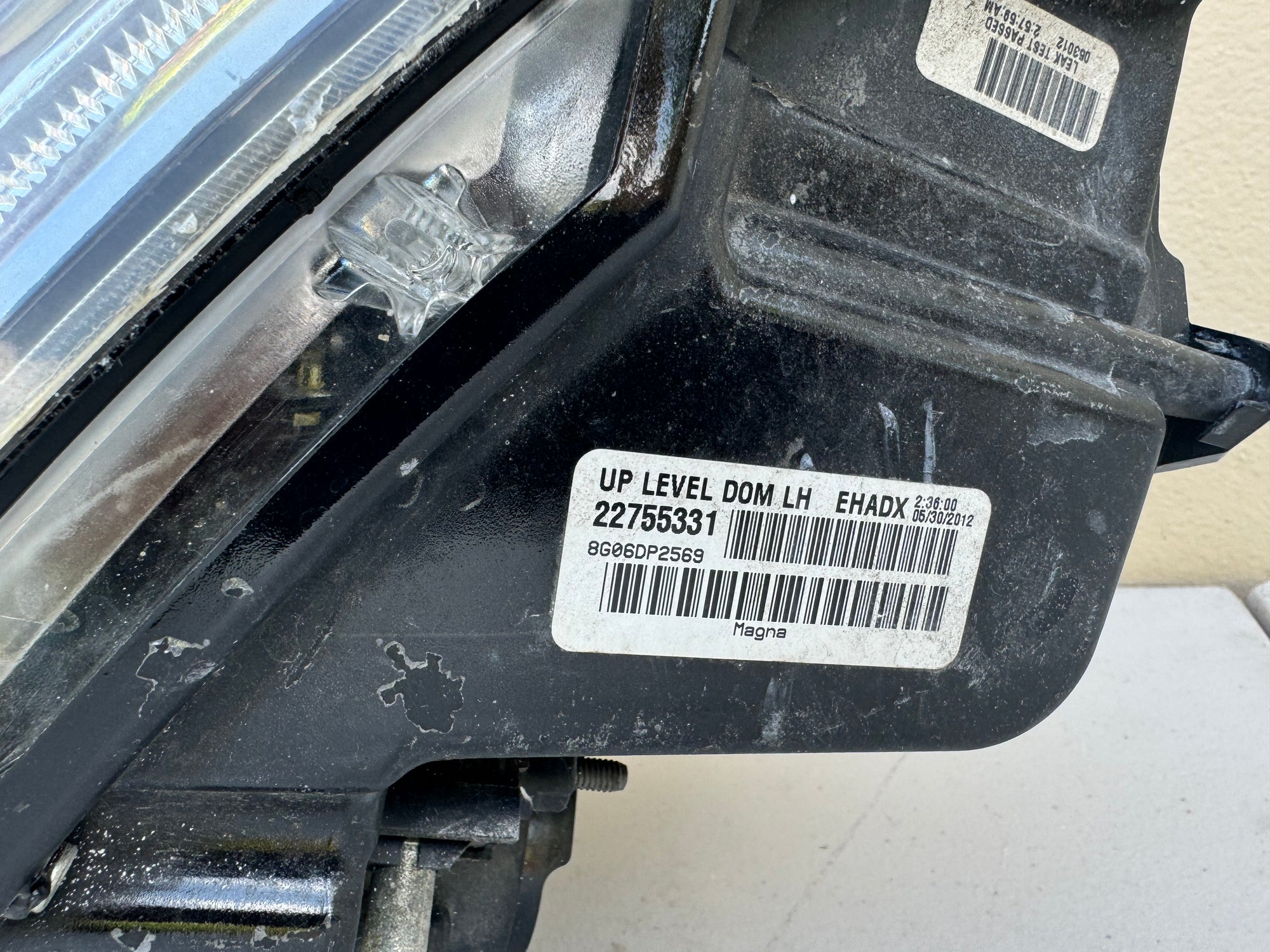 2008-2014 Cadillac CTS Left LH Xenon HID Headlight OEM assembly with visible barcodes and text on a white background